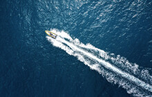 High Angle View Of A Motorboat Speeding On The Ocean With Copy Space