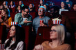 Multigenerational friends in movie theater.