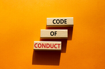 Code of conduct symbol. Wooden blocks with words Code of conduct. Beautiful orange background. Business and Code of conduct concept. Copy space.