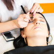 © Jaroslav Moravcik - Beautician making eyelash extension procedure