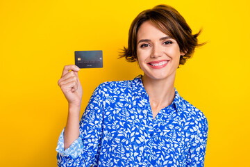 Poster - Photo of positive pretty lady wear blue stylish clothes recommend bank olastic card isolated on yellow color background