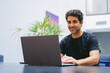 © juanpablo - Middle-aged Latin writer with a smile working on his novel from his laptop. Copy space.