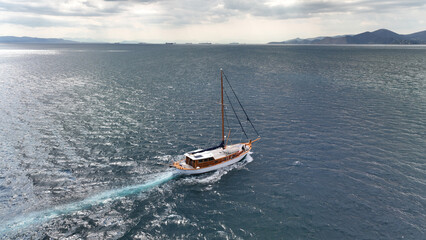 Wall Mural - Aerial drone photo of wooden sail boat cruising deep blue Mediterranean sea