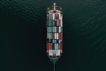  A Large Container Ship In The Middle Of The Ocean With Lots Of Containers On It's Side And A Tug Boat In The Middle Of The Water.  Generative Ai