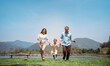 © Kiattisak - Happy family in the nature travel. family on weekend playing together in the meadow with river Parents hold the child and daughter hands.health life insurance plan concept.