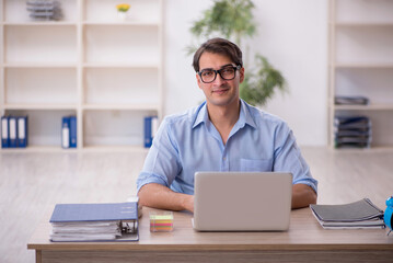 Young male employee working in the office