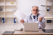 © Elnur - Old male doctor in telemedicine concept