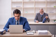 © Elnur - Two male colleagues working in the office