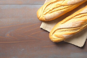 bread on a wooden board, two freshly baked loaves, freshly baked bread on a wooden table