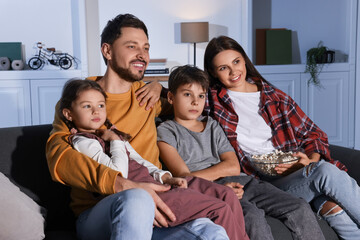 Poster - Family watching TV at home in evening