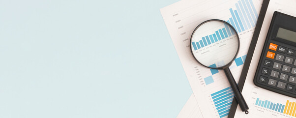 Business graphs, charts, magnifying glass and calculator on table. Financial development, Banking Account, Statistics