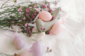 Wall Mural - Easter eggs with flowers on white linen fabric. Spring and Easter concept.