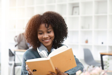 Wall Mural - portrait of happy smile african american girl lecture on book and looking on camera