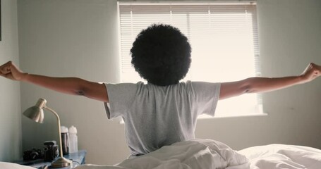 Poster - Bed, sleep and stretching by black woman waking up in the morning, rest and relax in her home. Rear view of African American woman sitting up in her bedroom, ready for day and looking out of window