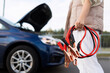 © Ivan Traimak - close-up of a car voltmeter in the hands of a woman against the background of a broken car