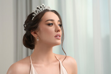 Wall Mural - Beautiful young woman wearing luxurious tiara indoors, space for text