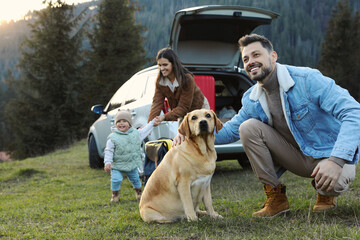 Sticker - Happy man with dog, mother and her daughter near car in mountains. Family traveling with pet