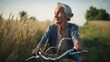 Cheerful senior woman with grey hair riding bicycle in the scenic fields landscape. Portrait of happy grandmother. Outdoor nature background. Healthy lifestyle. AI generative illustration.