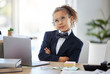 Bored, kid and thinking with pretend office work and laptop with ideas. Job, child and little girl playing dress up as working executive at desk with paperwork and eyes rolling feeling annoyed