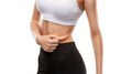 © Dimid - Girl pulls the skin on the abdomen, showing the body fat. Treatment and disposal of excess weight, the deposition of subcutaneous fat.