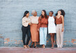 Laughing, diversity and a team of business black women outdoor on a blue brick wall for conversation. Talking, joking or bonding with a female employee and colleague group taking a break outside