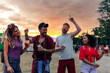 © bernardbodo - Group of young friends enjoy drinks at festival