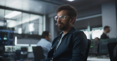Fototapete - Handsome Indian Software Developer Working on Computer in a Technological Laboratory Environment. Young Man is Thoughtful at His Workplace, Drafting Research Ideas for an AI Development Blockchain