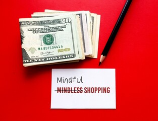 Cash dollar money on red background with pencil correct MINDLESS SHOPPING, to MINDFUL SHOPPING, to overcome impulsive purchase to more conscious thought of what we plan to buy