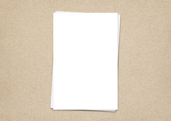 The mock-up blanks sheet of paper white a4 on a texture cardboard background color beige top view 