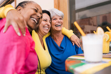 Happy Senior People Having Fun Together At Bar Restaurant Outdoor - Elderly Joyful Lifestyle - Focus On Right Woman Face