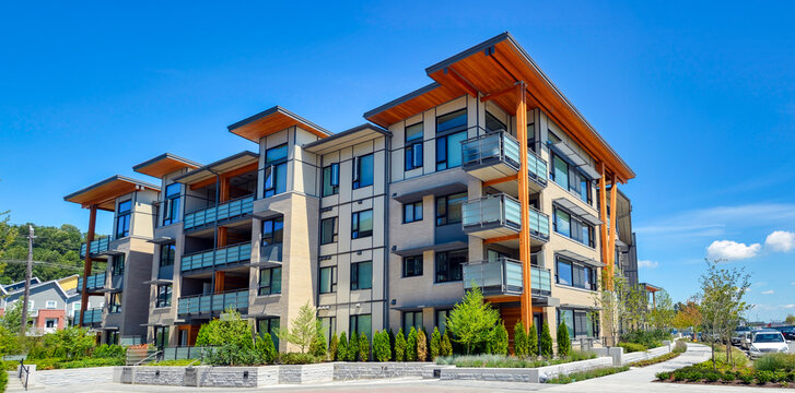 brand new apartment building on sunny day in british columbia, canada
