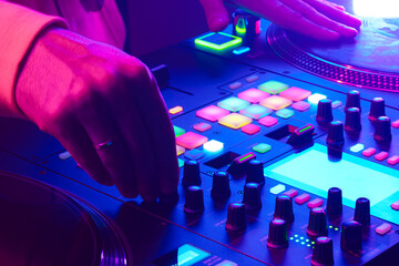 Wall Mural - Hands of a DJ creating and regulating music on dj console mixer at club concert