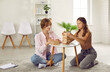 © Studio Romantic - Teen girl on therapy session with school psychologist is building from wooden blocks. Woman psychologist sits at table on floor and working with girl. Establishing contact, therapy psychological help.