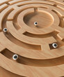 Conceptual ball bearing on a wooden maze puzzle with multiple options 3d render
