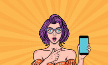 Sexy Young Woman With Wide Open Eyes In Glasses Points To A Smartphone For Your Proposal. Vector Illustration In Pop Art Style.