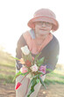 A bunch of tulips for you: young teenager girl wearing glasses and hat holding a bunch of tulips