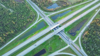 Poster - Aerial view of freeway overpass junction with fast moving traffic cars and trucks. Interstate transportation infrastructure in USA