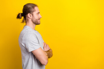 Sticker - Photo of confident attractive guy dressed grey t-shirt arms folded looking emtpy space isolated yellow color background