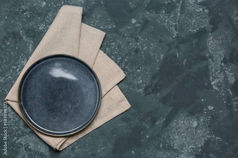 Plate with clean napkin on dark color background