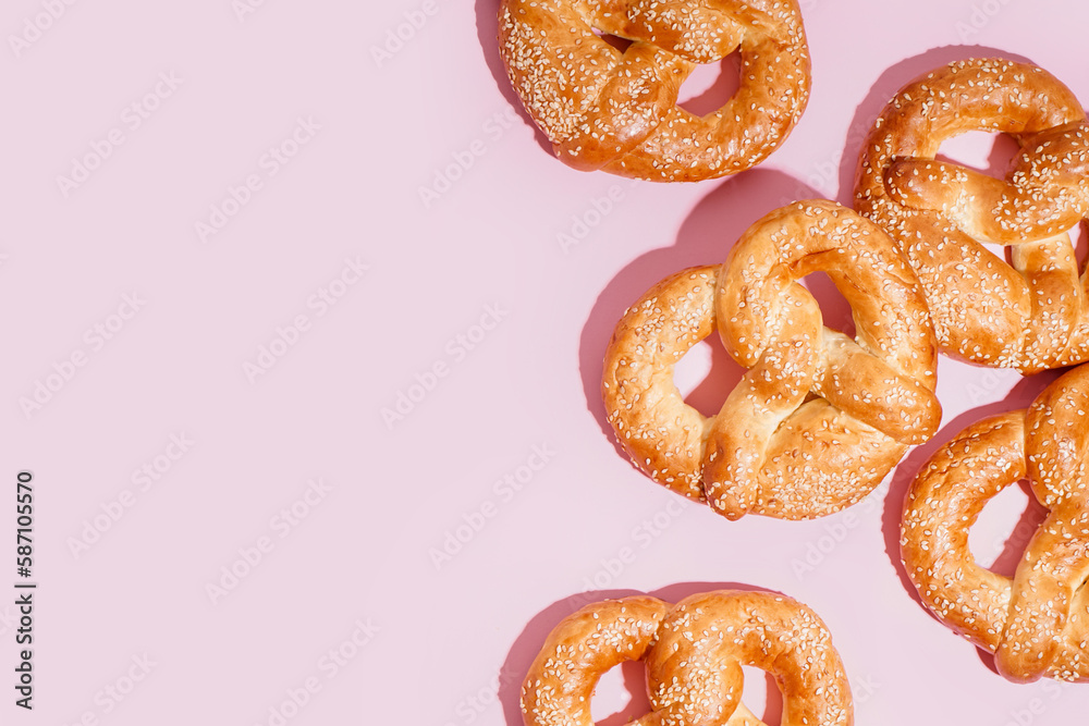 Tasty pretzels on pink background