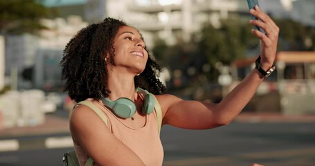 Wall Mural - Selfie, black woman and phone being happy, communicate and smile while outdoor in the city with headphones. Lady, girl and smartphone for video call, relax and talking online being confident or proud