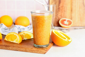 Wall Mural - Glass of healthy orange smoothie on table