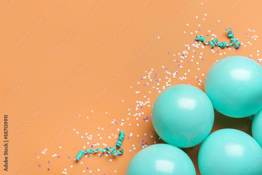 Blue balloons, ribbons and serpentine on orange background