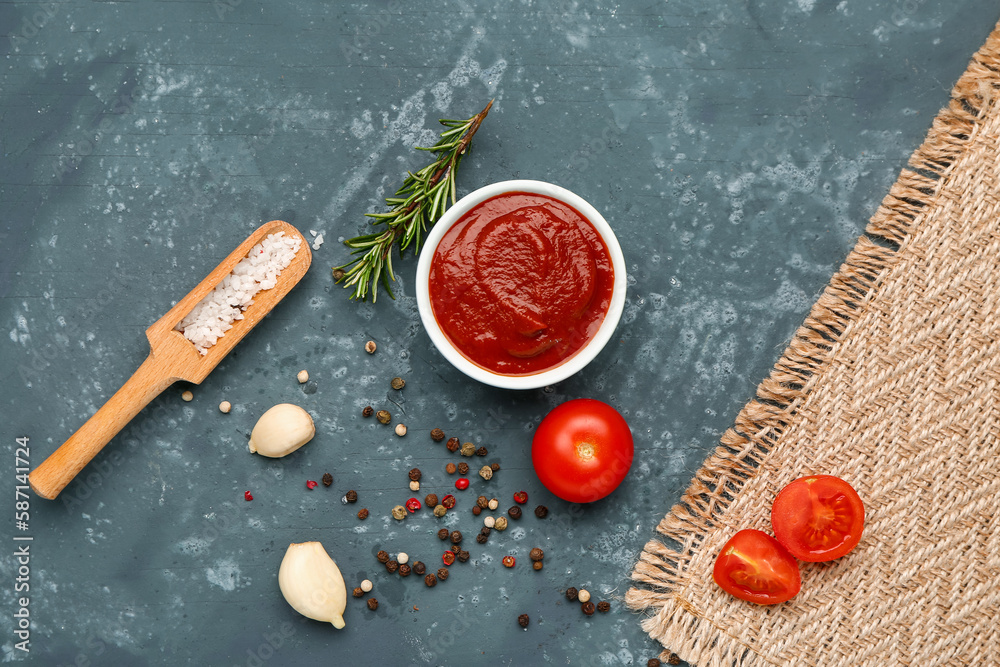 Bowl with tasty tomato paste, garlic and spices on grey grunge background