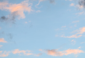 Wall Mural - Blue sky background with pale pink clouds at sunset