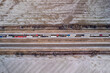 Aerial view of highway in Oklahoma after snow storm with traffic. Trucks and cars are going on interstate along fields.