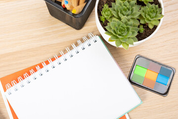 Wall Mural - Notebook mockup with school stationery on a wooden table. back to school concept. Blank notepad with copy space. list of goals and plans for new year 2023