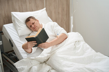 Wall Mural - Handsome man is resting during the medical procedure in the clinic