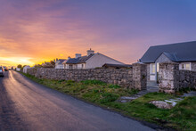 Sunrise At The End Of The Road With Old Irish Cottages And Stone Walls On Inishmore Island