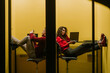 © qunica.com - Tired young business colleagues having video call at modern soundproof phone booth at the office